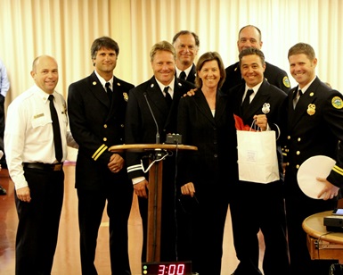 Supervisor Katie Rice poses and smiles with Fire Chief Jason Weber and six members of the Marin County Fire Water Rescue Task Force.