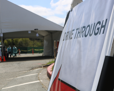 A sandwich board sign says "Drive Though" at a coronavirus testing site in Marin County.