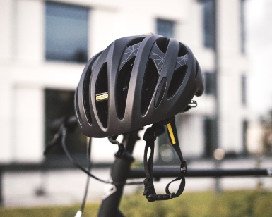 A closeup view of a bicycle helmet sitting on a bike seat.