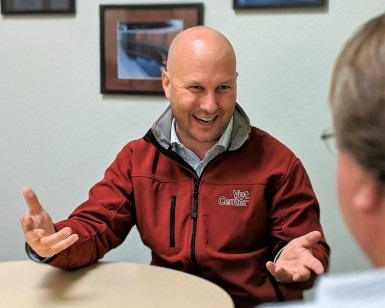 Dr. Jesse Wade, facing the camera, speaks with a military veteran, whose face is not shown.