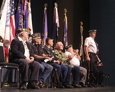 A group of military veterans sit on stage during the 2014 Veterans Day ceremony at Marin Center.