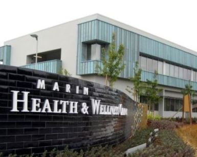 A view of the Marin Health and Wellness Center, with the sign in the foreground and building in the background.