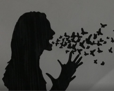 A black-and-white piece of artwork shows a silhouette of a woman with her mouth open and butterflies flying out of her mouth.