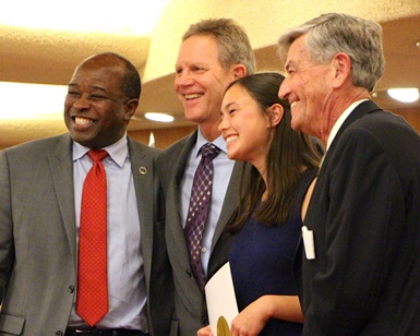 Four people smile for the camera during the volunteers and interns celebration on January 5, 2016.