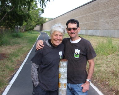 Beverly and Mark Birnbaum pose on the bike trail that they help keep clean.