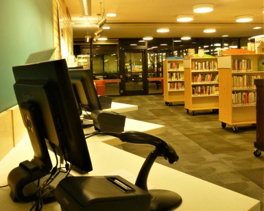 Interior photo of the Novato Library with a computer and bookshelves