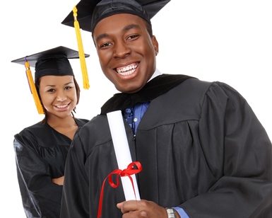 A young man and a young woman hold diplomas while wearing graduation gowns