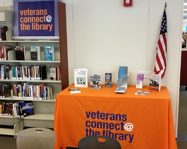 A view of the table at the South Novato Library with books, DVDs and pamphlets designed for military veterans.