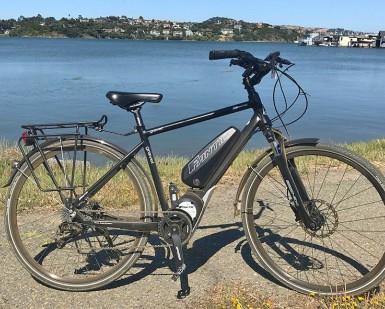 A e-bike sits on a paved trail.