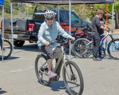 A woman rides an electric bike.