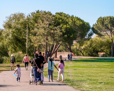 A small group of people in the distance are shown walking on a pathway through Lagoon Park in San Rafael.