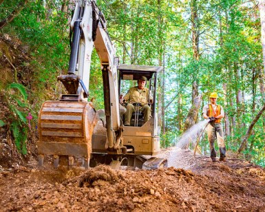 Two crew members work on a trail at at an open space preserve.