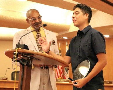 Dan Daniels (left) presents an award to Benjamin Magana (right).