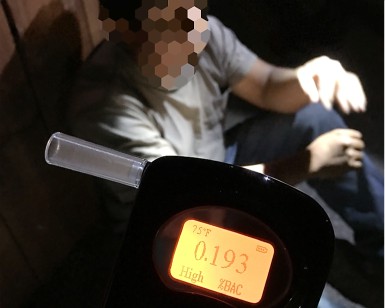 In the foreground, a Breathalyzer reading shows an illegal blood-alcohol level as a probationer with a blurred-out face sits in the background.