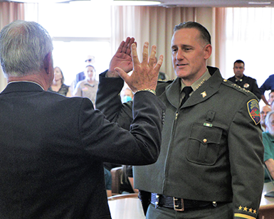 Jamie Scardina, on right, raising right hand and reciting oath of office to retired sheriff Bob Doyle