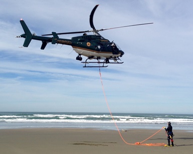 A helicopter called Henry 1 lands on the beach at Dillon Beach in preparation for a water rescue.