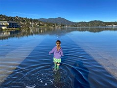 Young girl wading in water
