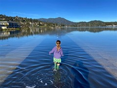 Young girl wading in water
