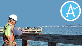 Man in hardhat working on pier with Measure A logo