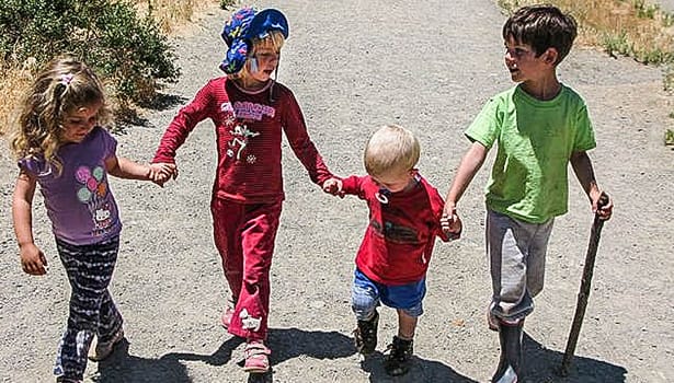 Kids on trail holding hands