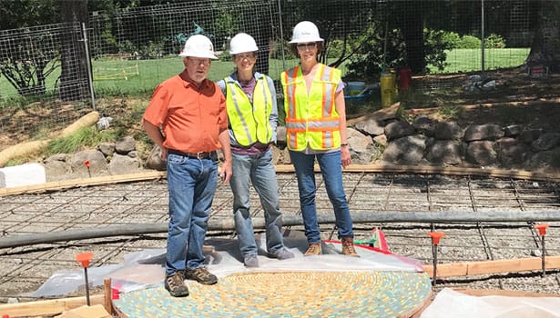 Landscape architecture team in hard hats next to labyrinth construction